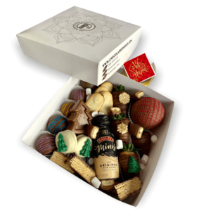 Deliciosa caja con una combinación de bombones, galletas, fresas, una choco bomba, y chocolate en forma de arbolito de navidad y una botellita de Baileys de 100 ml. Puedes personalizar la colilla